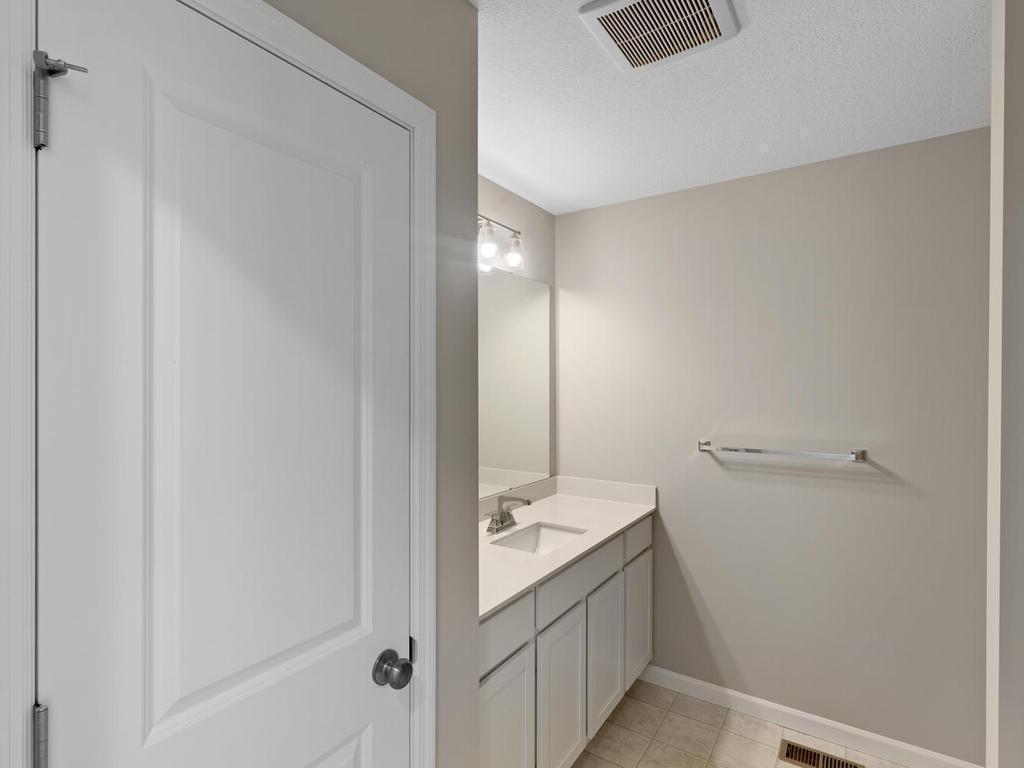 Main Level Bathroom. Photo taken of another home with similar plan and finishes. Photos and renderings may not depict actual plan, materials, & finishes may vary. All measurements are approximate.