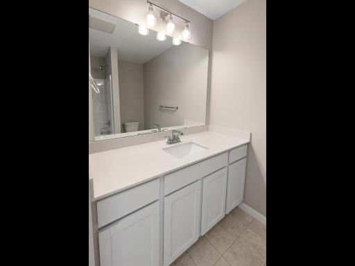 Main Level Bathroom. Photo taken of another home with similar plan and finishes. Photos and renderings may not depict actual plan, materials, & finishes may vary. All measurements are approximate.