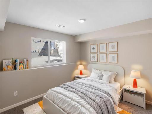 Finished Lower Level Bedroom 4, Virtually Staged. Photo taken of another home with similar plan and finishes. Photos and renderings may not depict actual plan, materials, & finishes may vary. All measurements are approximate.