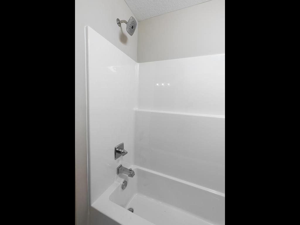 Main Level Bathroom. Photo taken of another home with similar plan and finishes. Photos and renderings may not depict actual plan, materials, & finishes may vary. All measurements are approximate.