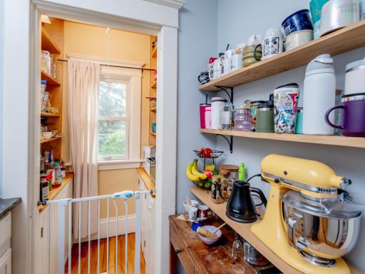 Walk-in pantry offers convenient, abundant storage right off the kitchen.