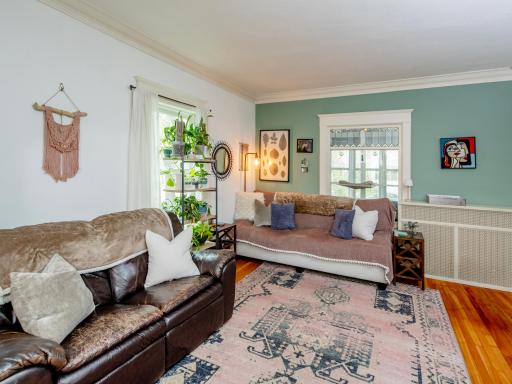 Spacious main-level living room featuring crown molding and abundant natural light.