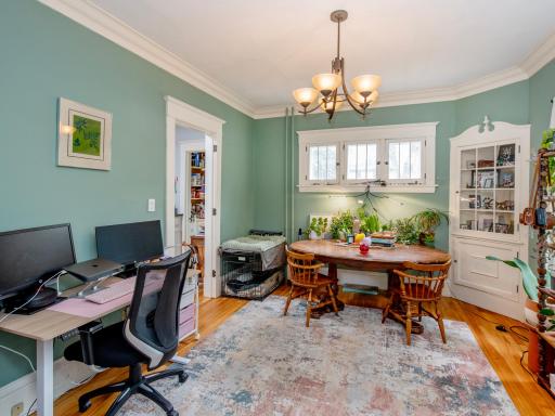 Sun-filled dining room with beautiful original built-in shelving that adds warmth and character.