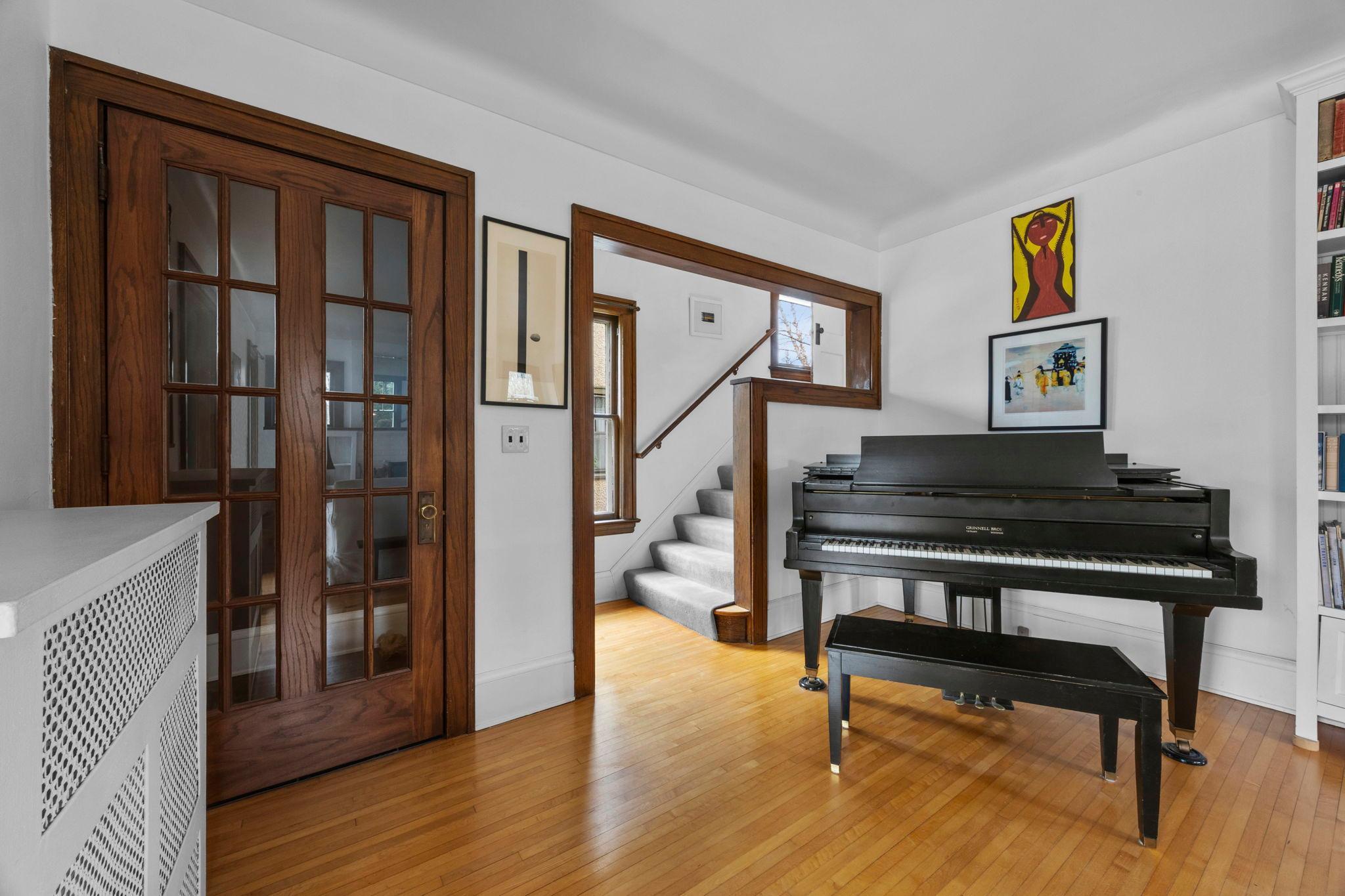 Living room piano by stairs