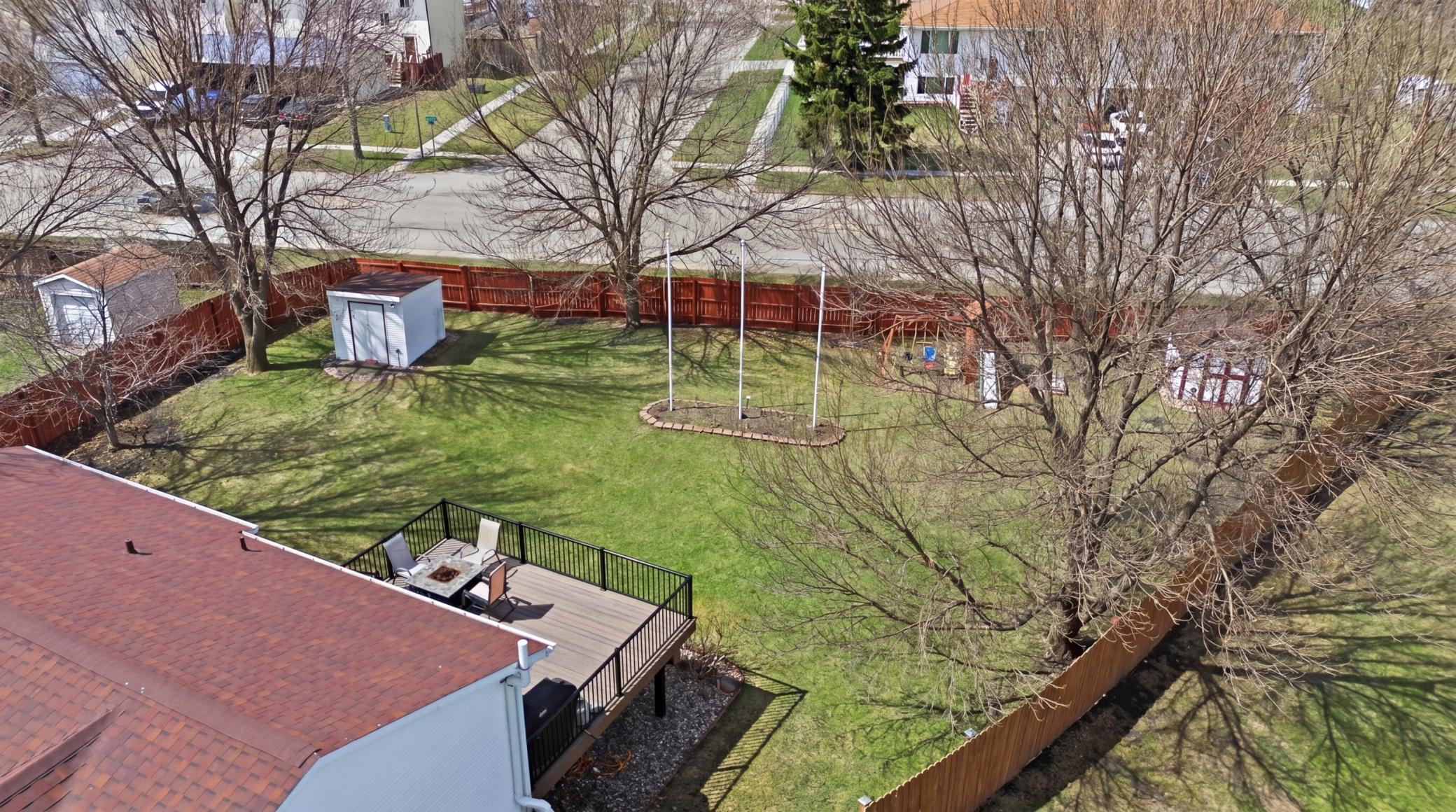Fully fenced yard with mature trees