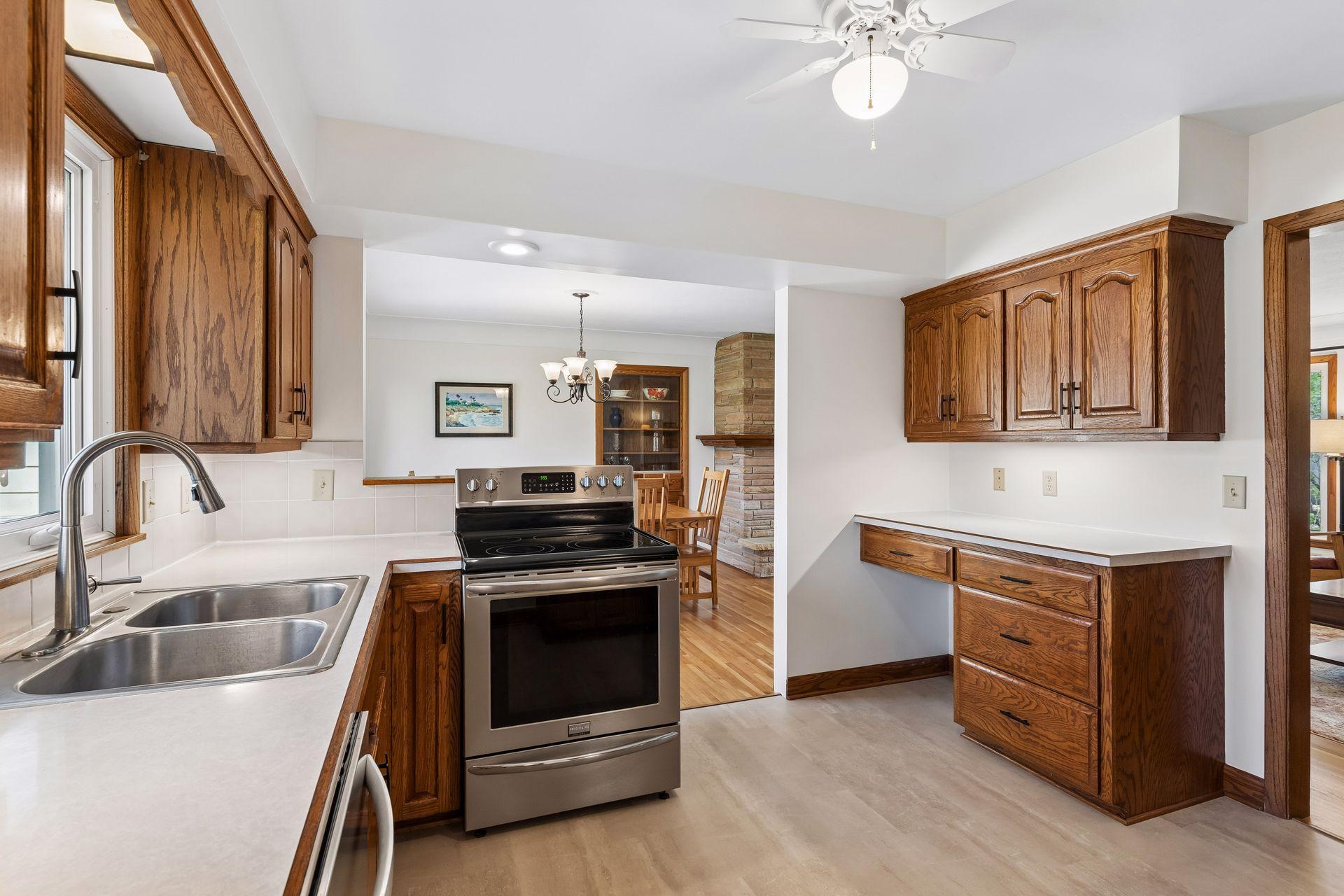12x11 Kitchen with Oak cabinets, new vinyl flooring, fresh paint, and stainless steel appliances. North-facing windows.