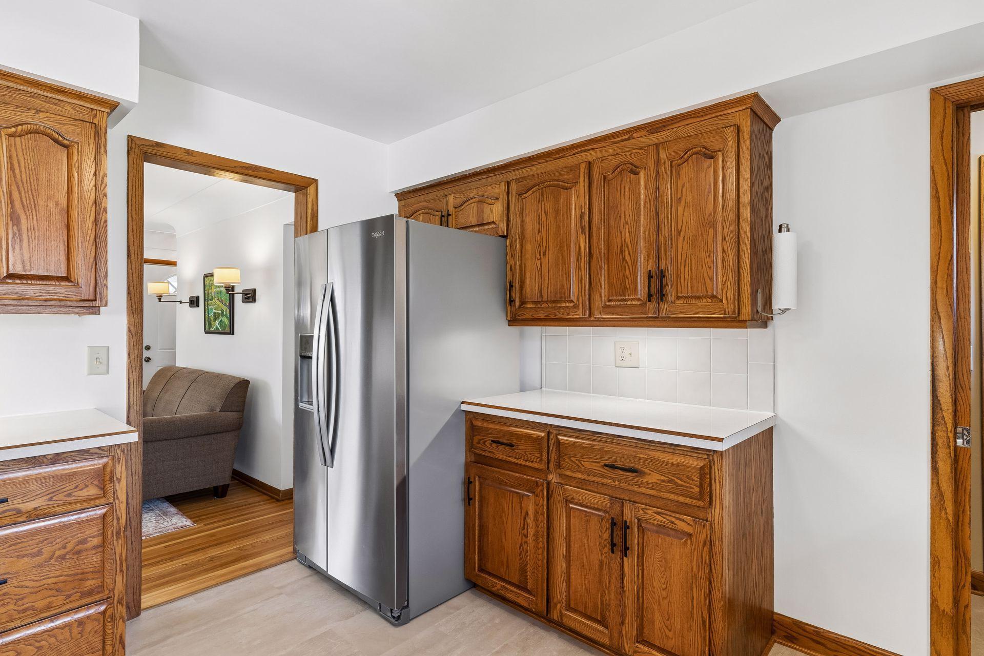 12x11 Kitchen with Oak cabinets, new vinyl flooring, fresh paint, and stainless steel appliances. North-facing windows.