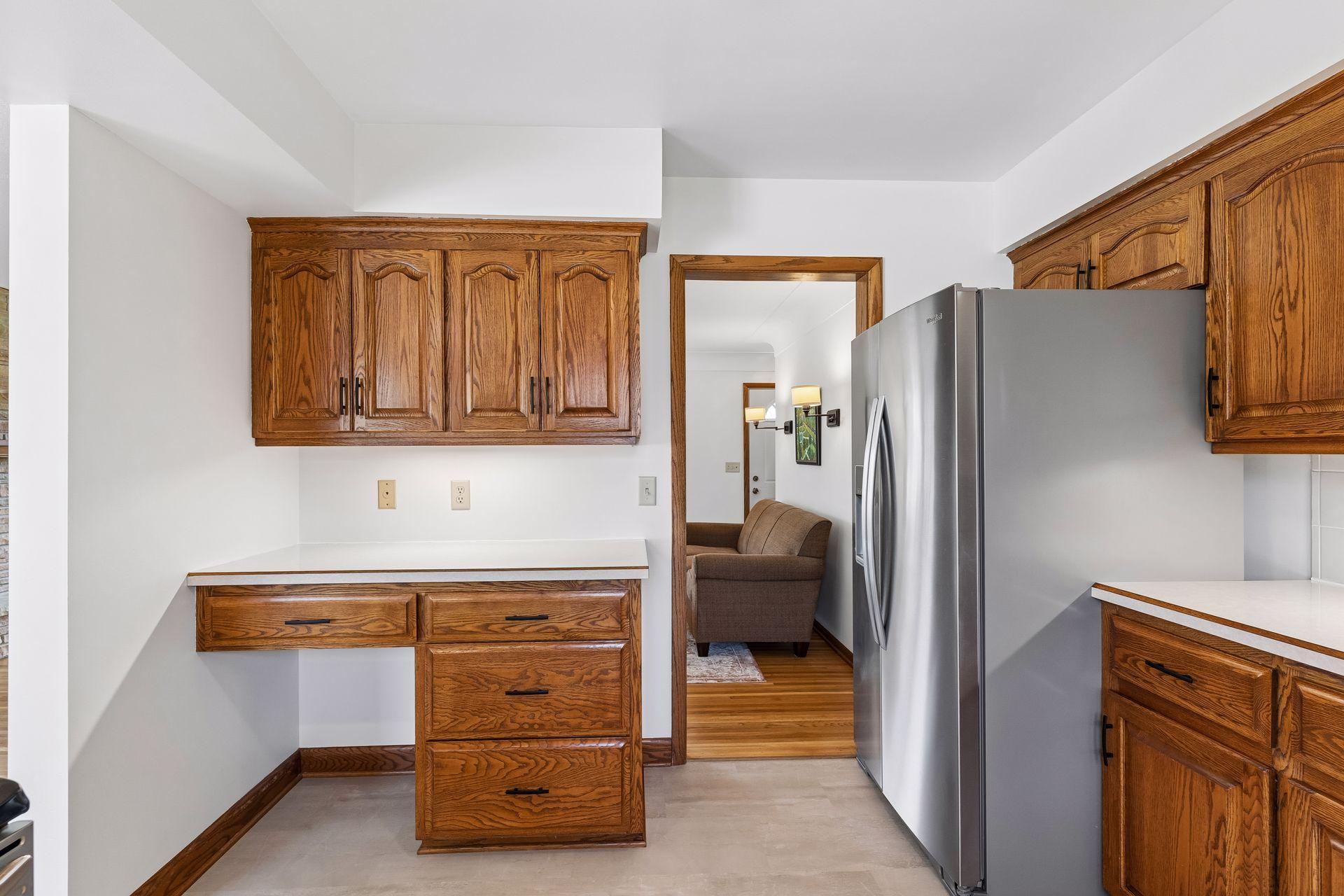12x11 Kitchen with Oak cabinets, new vinyl flooring, fresh paint, and stainless steel appliances. North-facing windows.