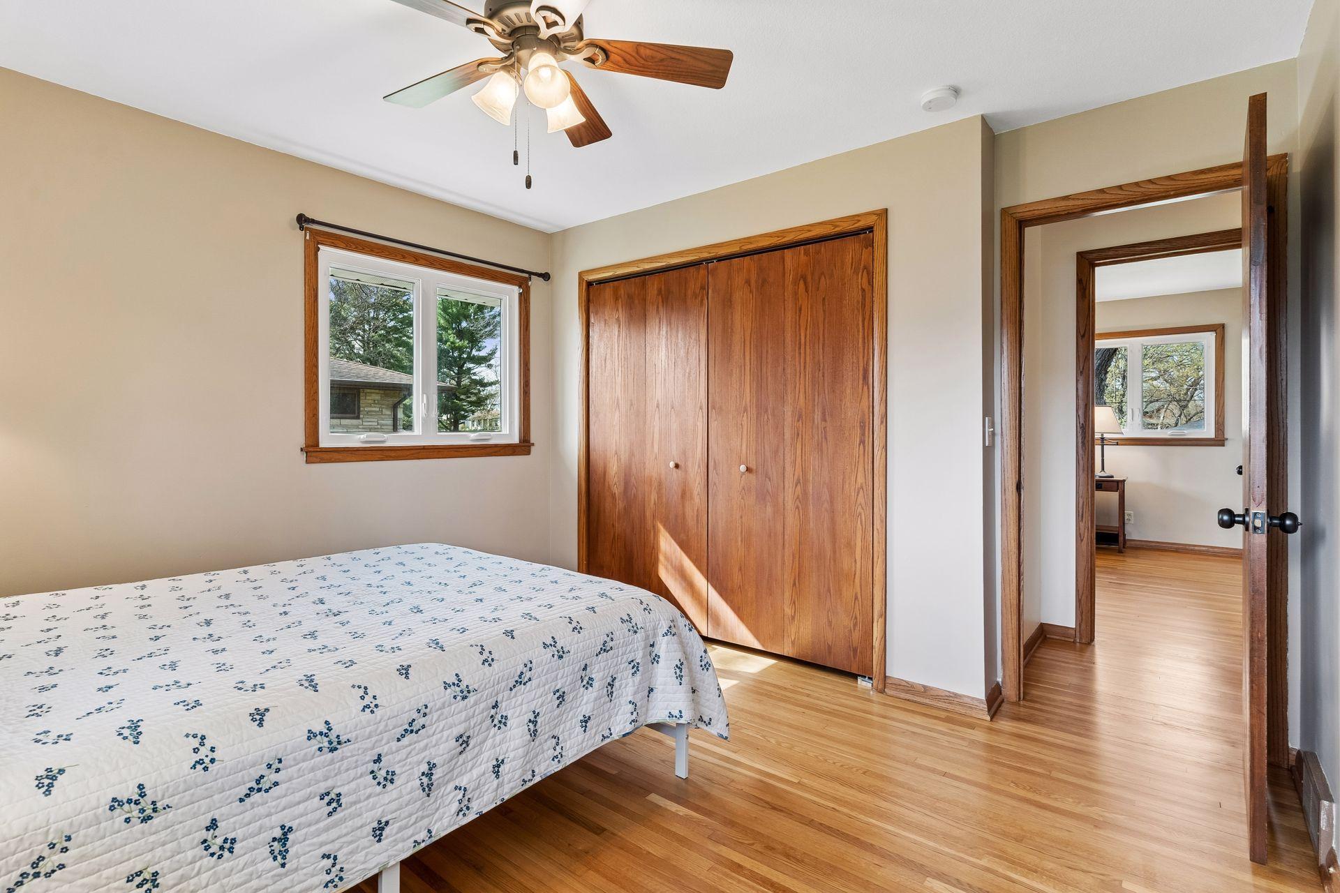 12x12 Main floor Bedroom #2 with freshly refinished oak hardwood floors, new paint, hardwood trim, updated west and south-facing windows.