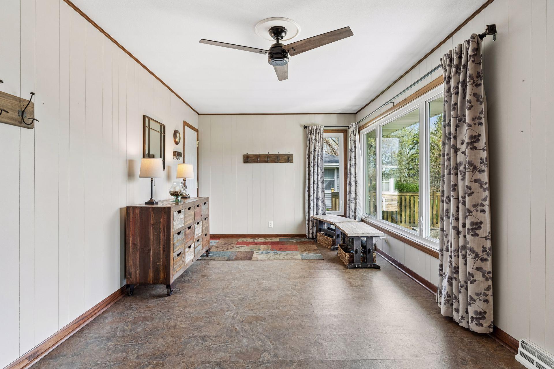 21x10 Main floor Sun room with vinyl flooring and 2-sided fireplace. Updated south-facing windows