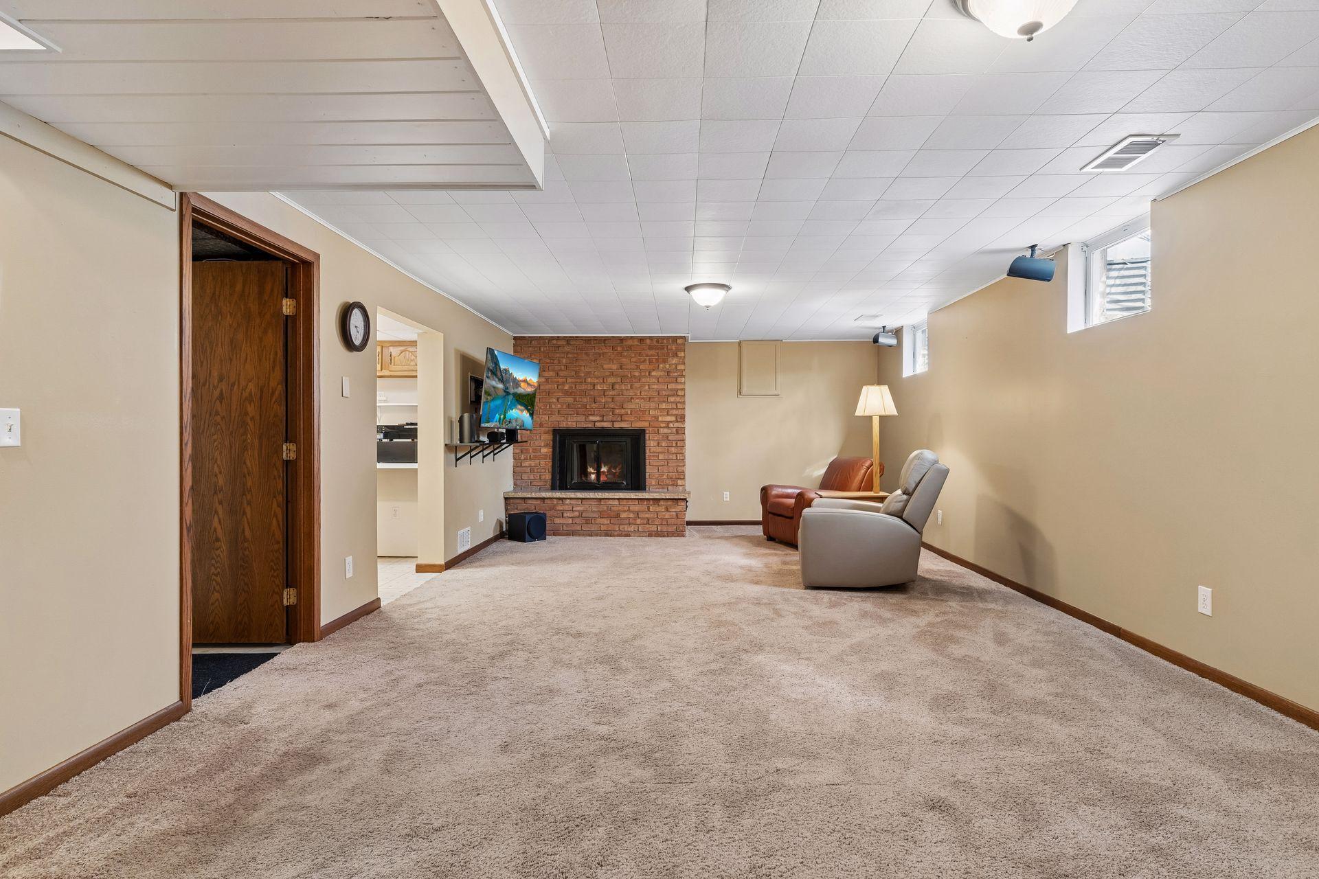 30x14 Lower Level family room with Wood Burning fireplace, and south-facing windows