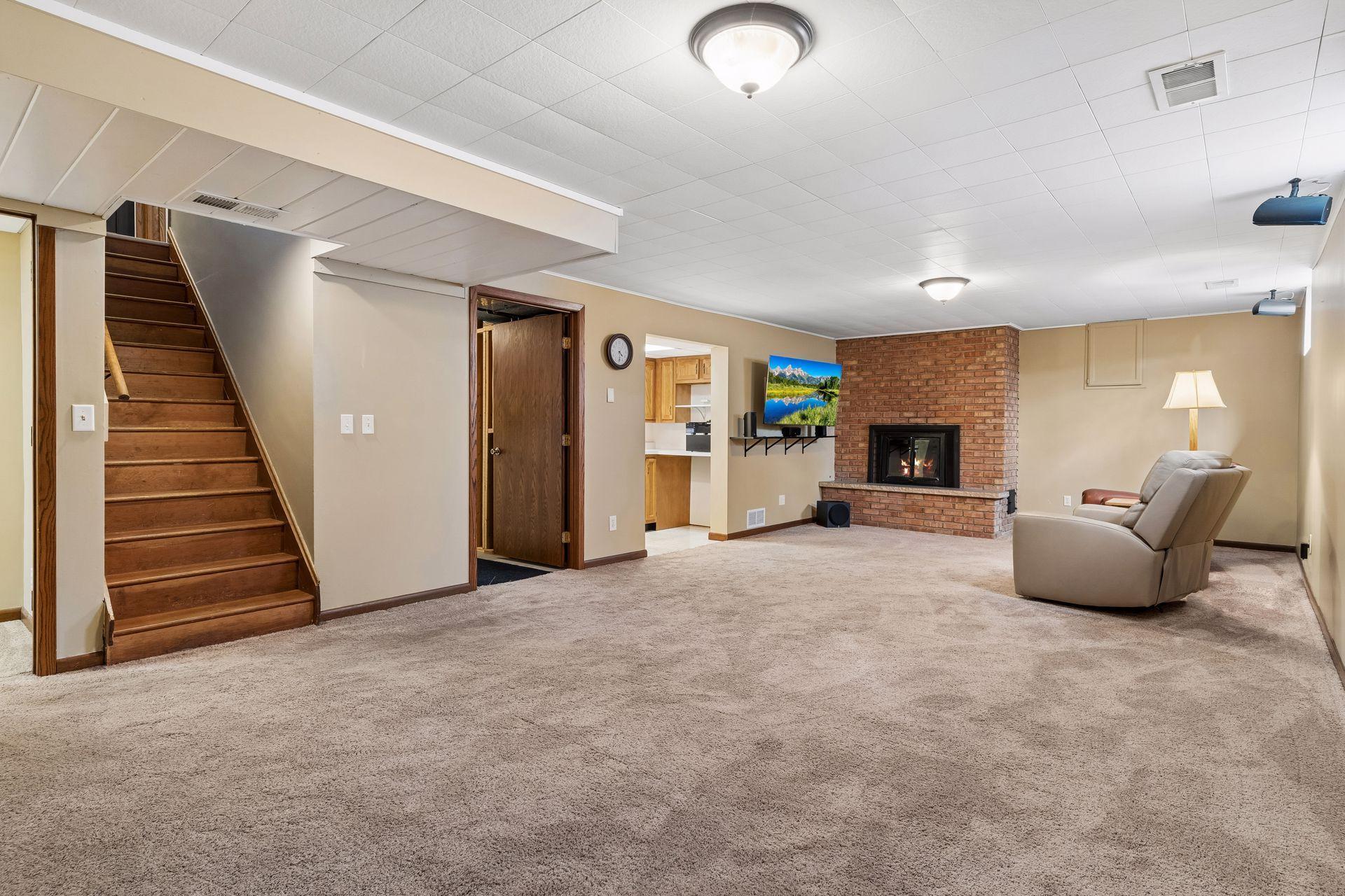 30x14 Lower Level family room with Wood Burning fireplace, and south-facing windows