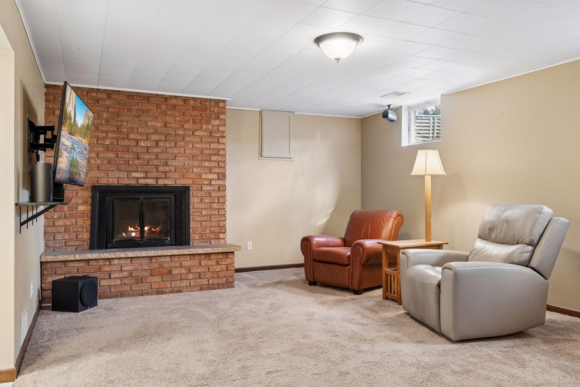 30x14 Lower Level family room with Wood Burning fireplace, and south-facing windows