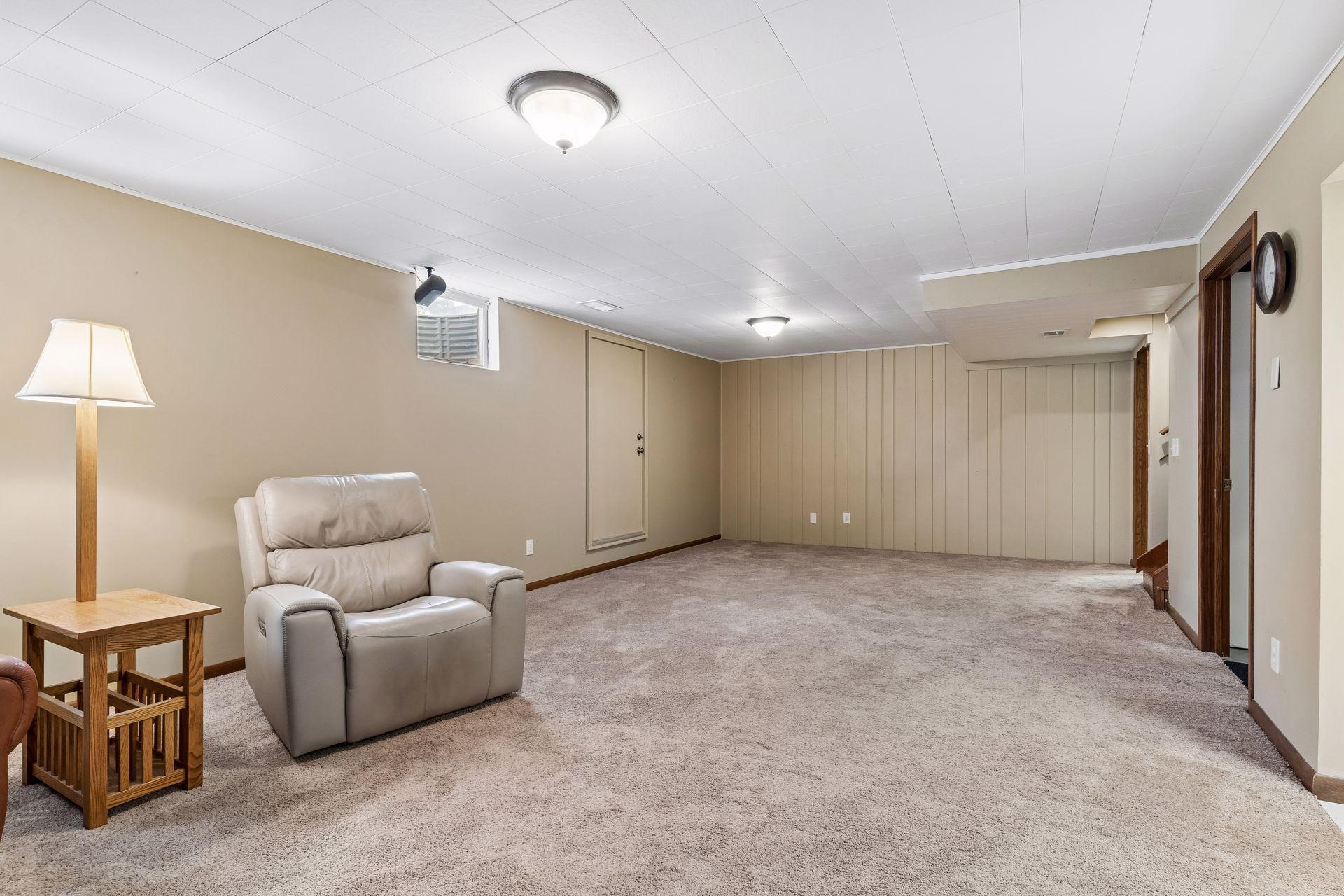 30x14 Lower Level family room with Wood Burning fireplace, and south-facing windows
