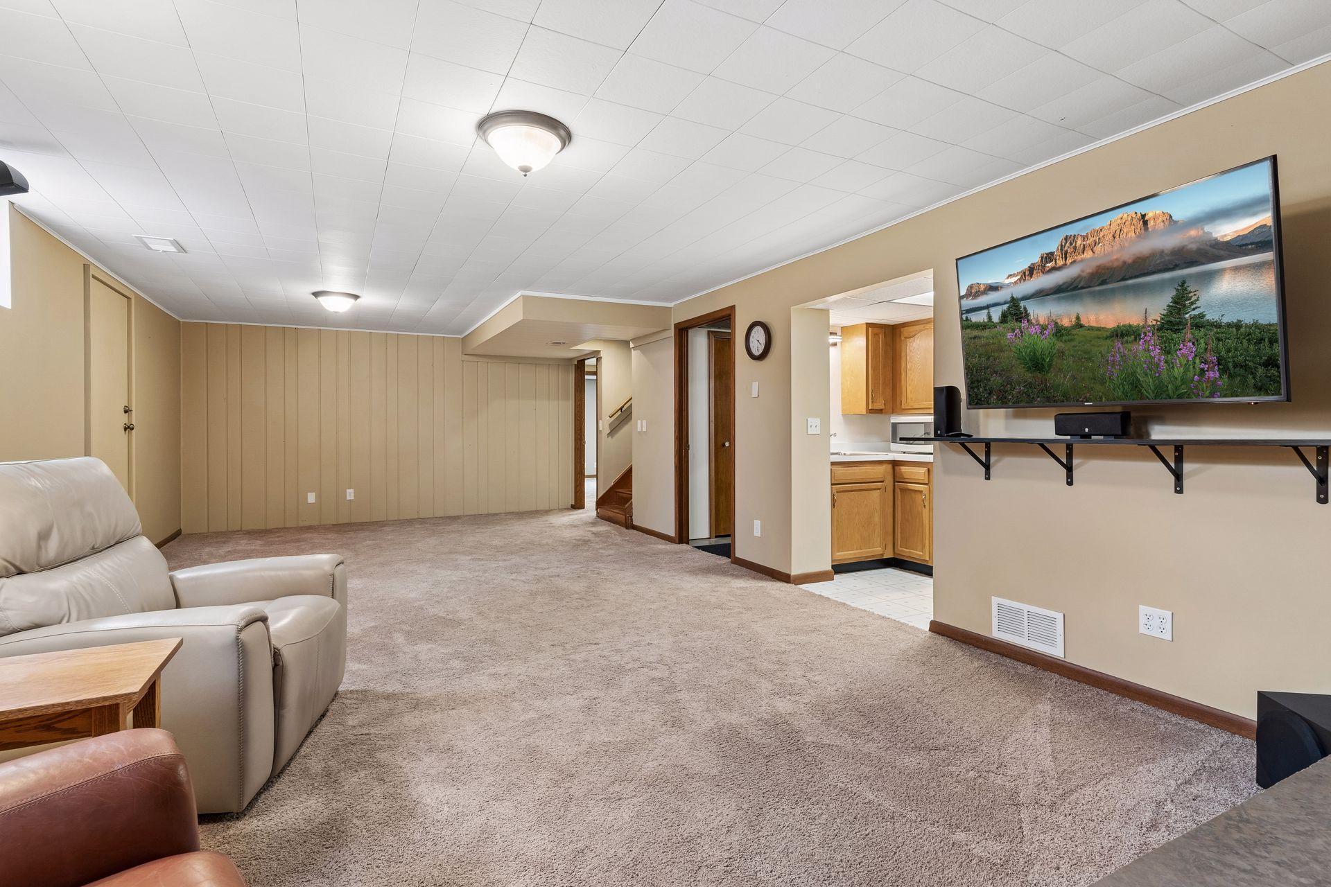 30x14 Lower Level family room with Wood Burning fireplace, and south-facing windows