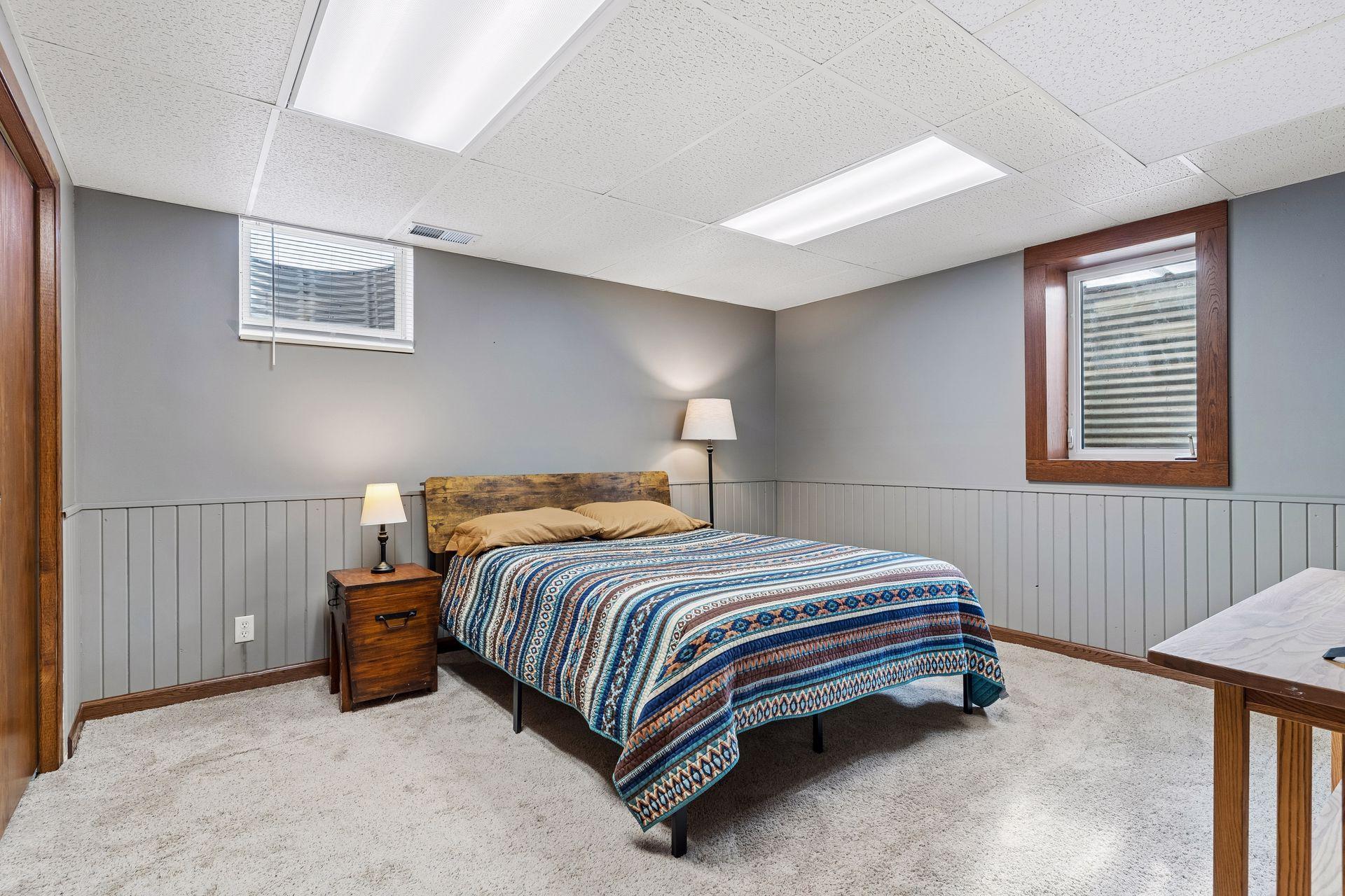 14x14 Lower Level bedroom #4 Freshly Painted Walls, wood trim, and west-facing egress window.
