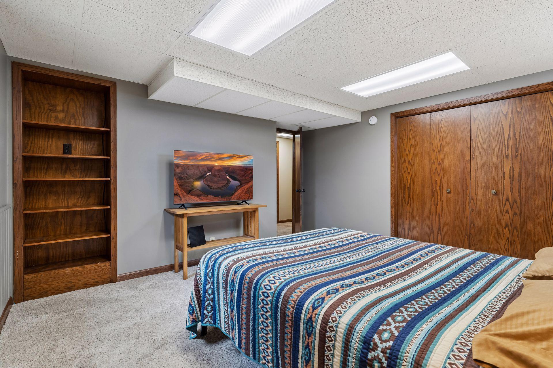 14x14 Lower Level bedroom #4 Freshly Painted Walls, wood trim, and west-facing egress window.