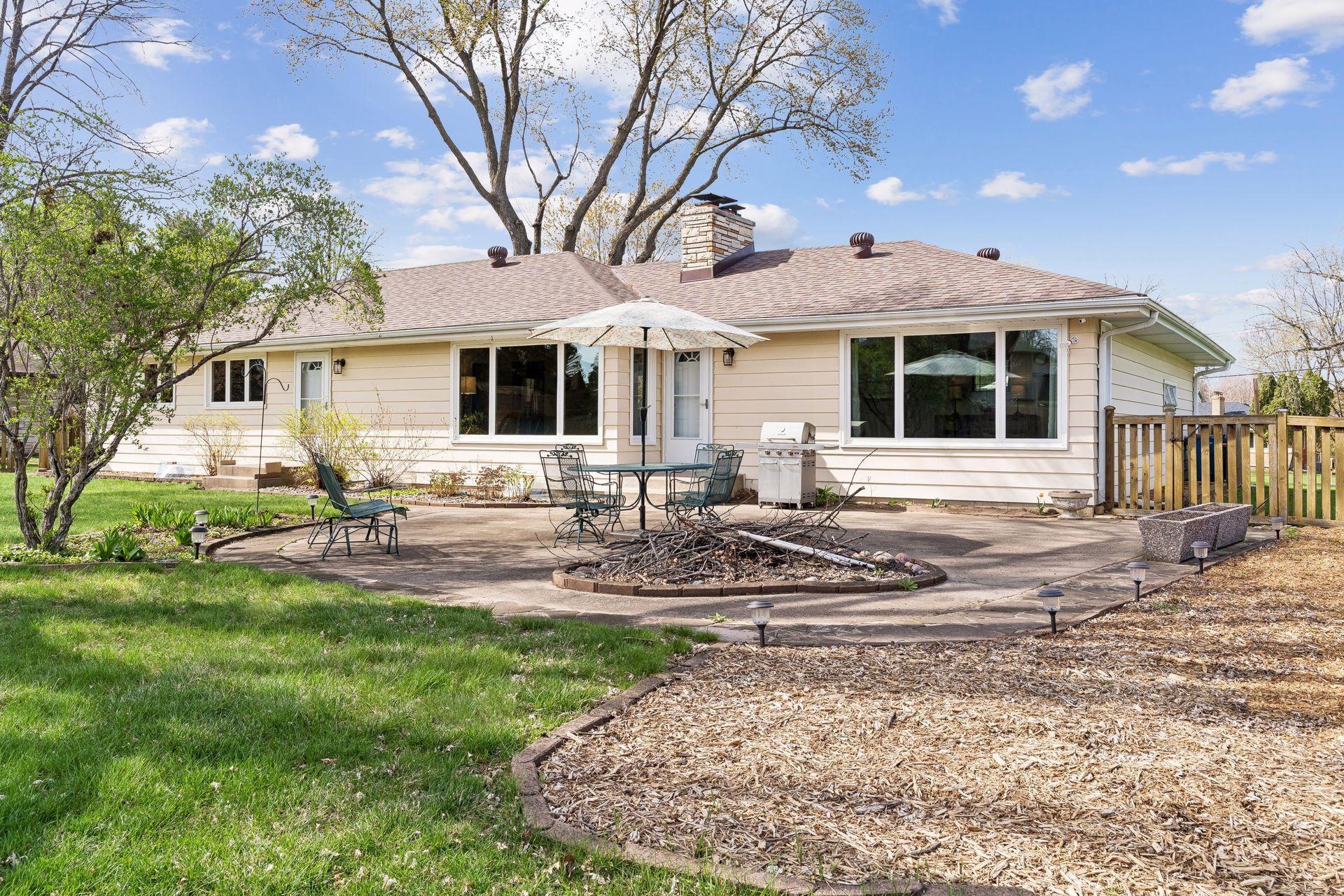 South-facing concrete backyard patio, Storage shed, and a wood fence.