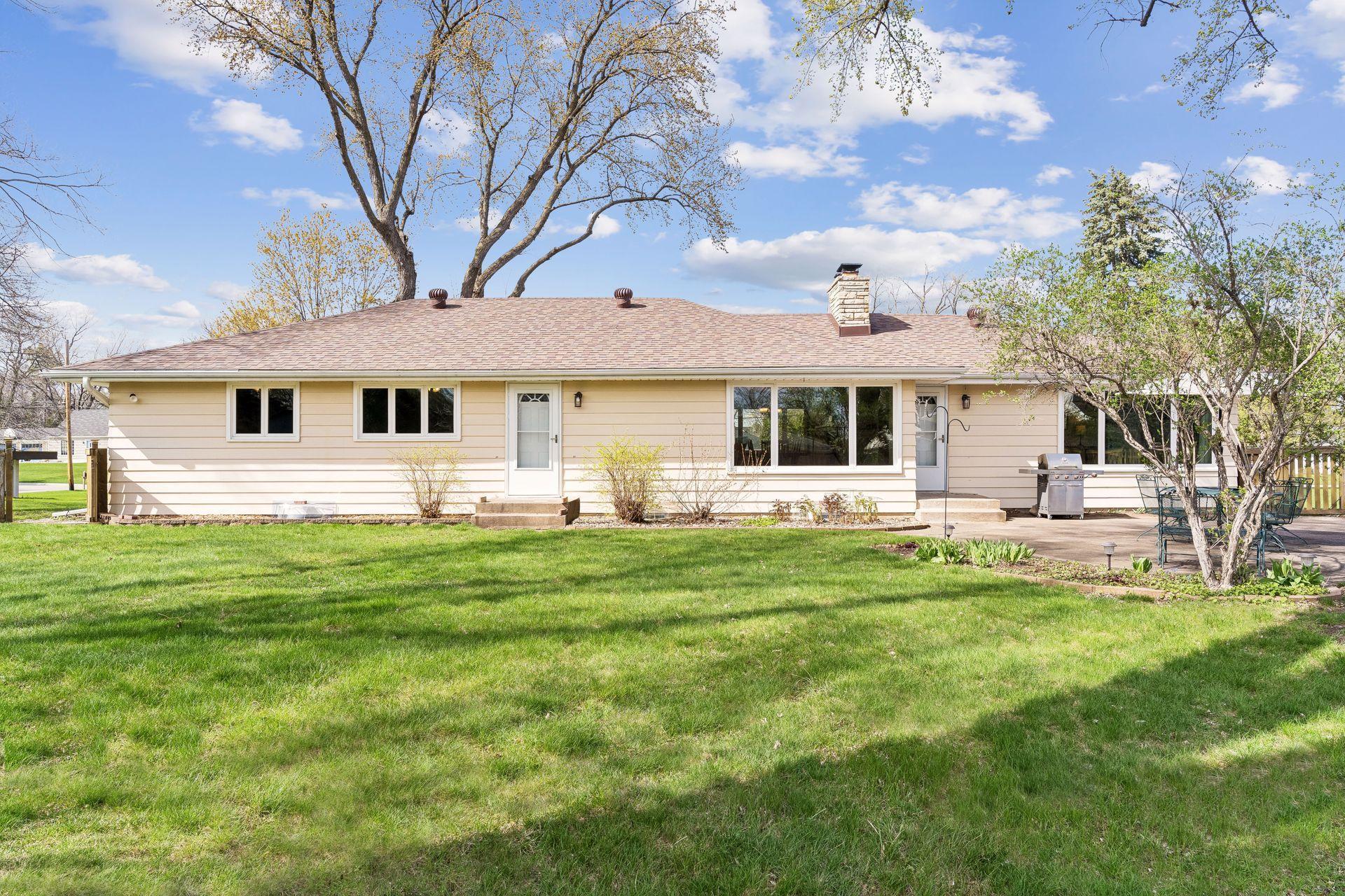 South-facing concrete backyard patio, Storage shed, and a wood fence.