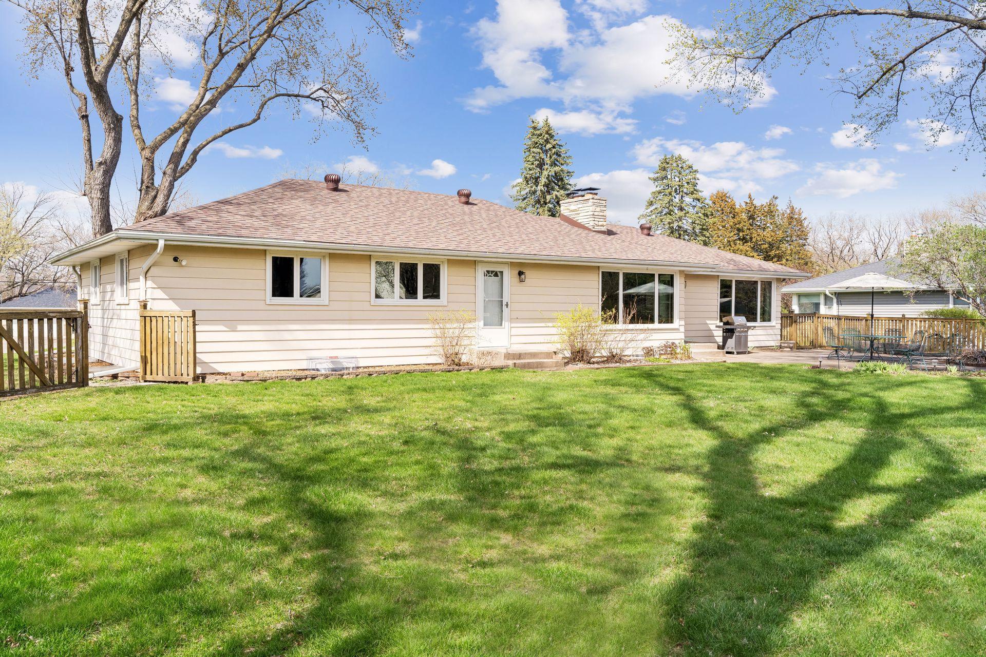 South-facing concrete backyard patio, Storage shed, and a wood fence.