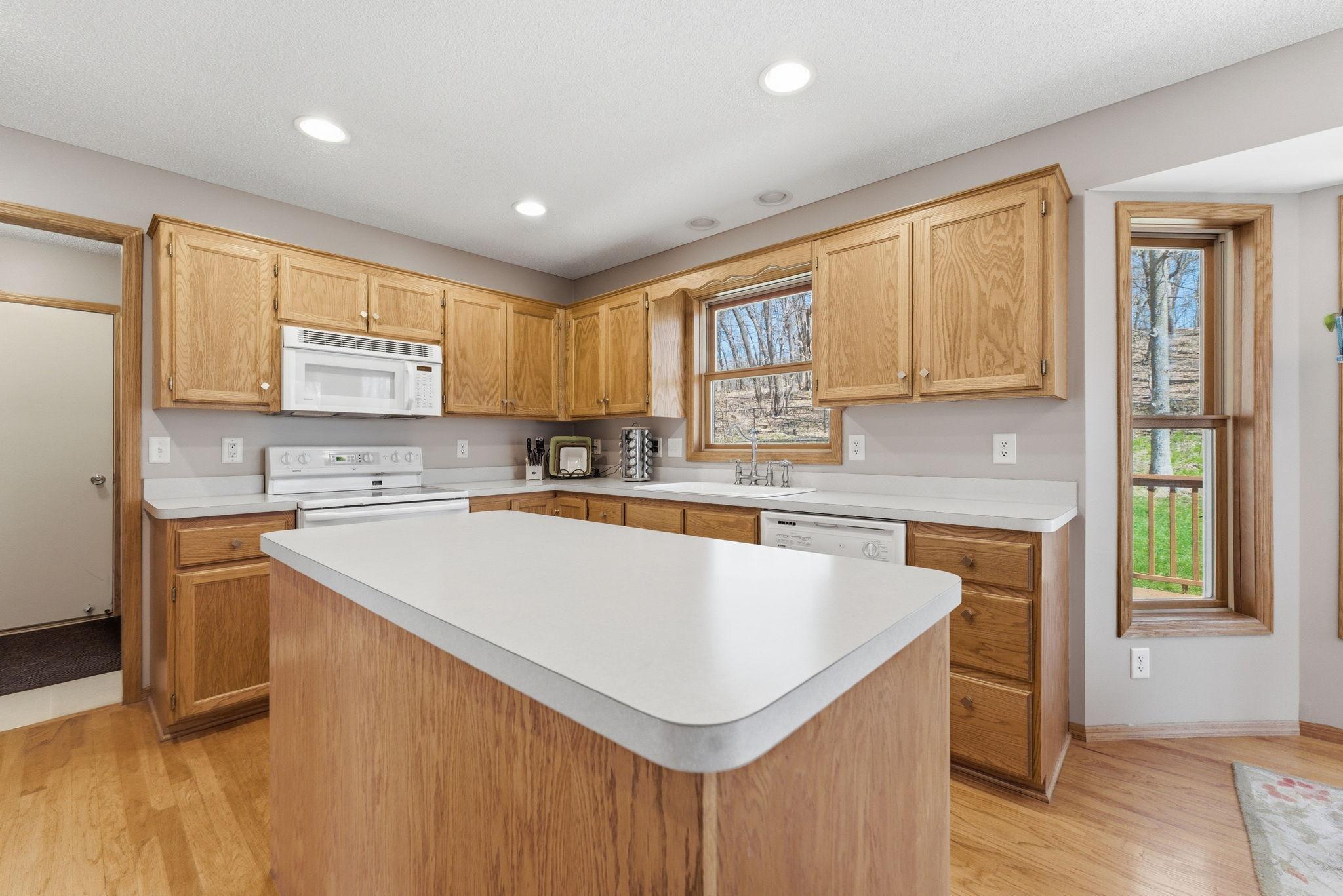 Center island kitchen with ample cabinetry and counter space.