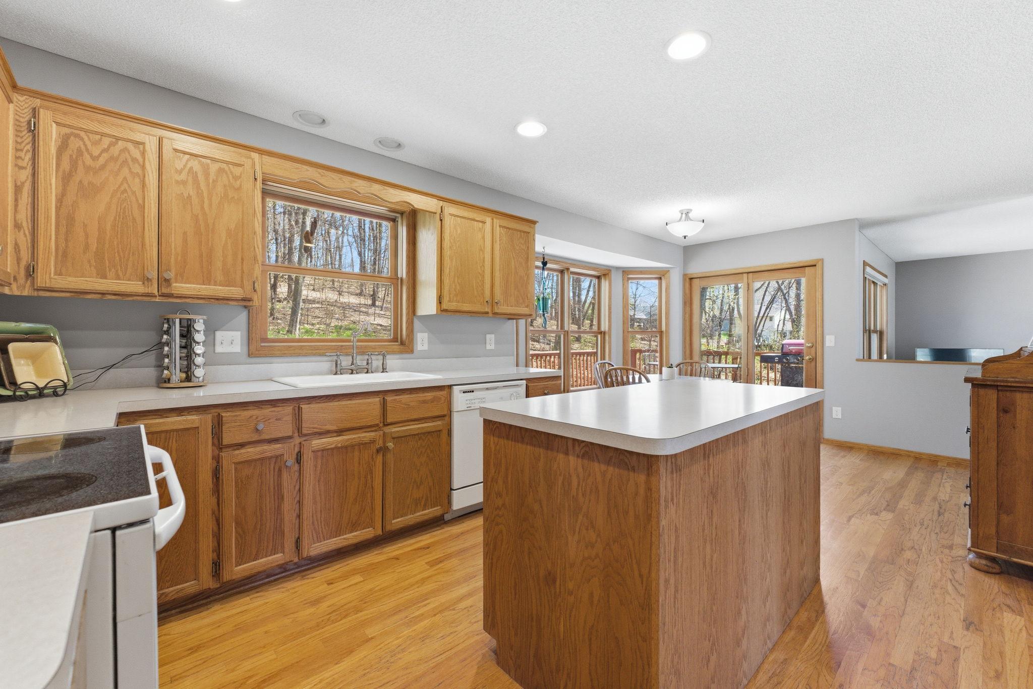 Real hardwood floors throughout the kitchen, informal dining room, front entry and formal dining room on the main level. Natural light fills the area through these amazing windows and patio door.
