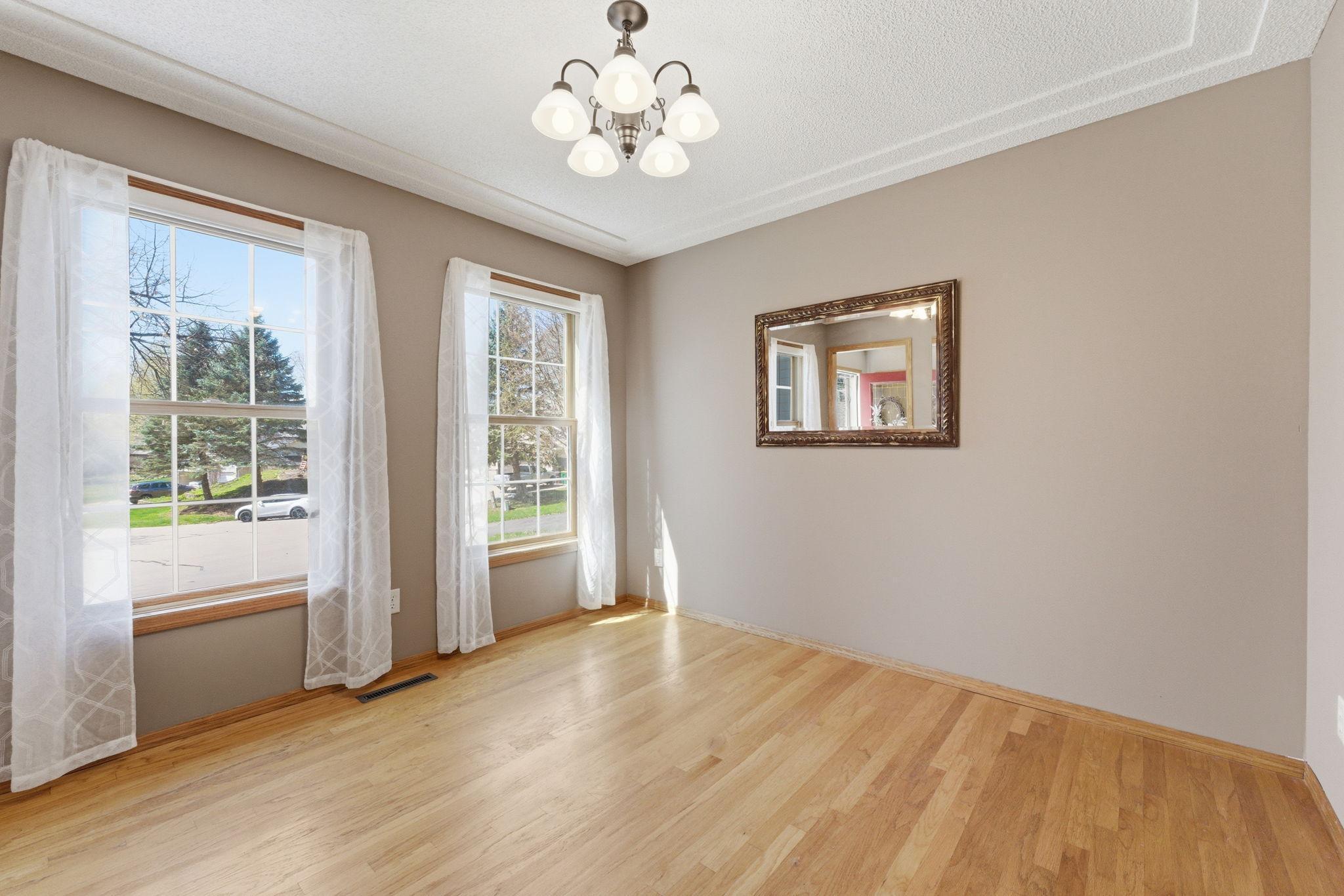 Main level flex room is perfect as a dining room, home office, or maybe a play room?? Double windows looking to front yard.