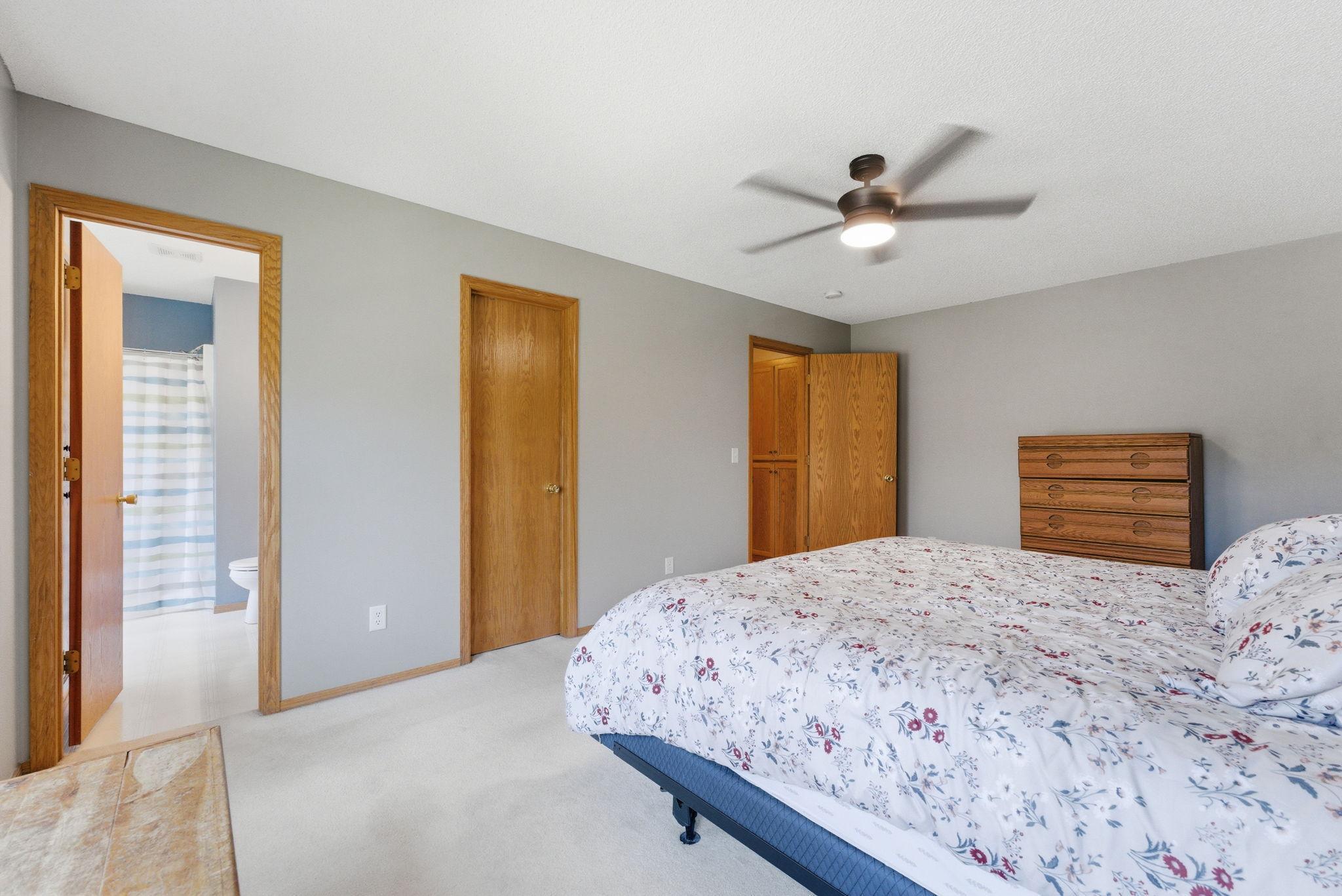 Spacious Primary bedroom with ceiling fan, walk-in closet, and private 3/4 bathroom