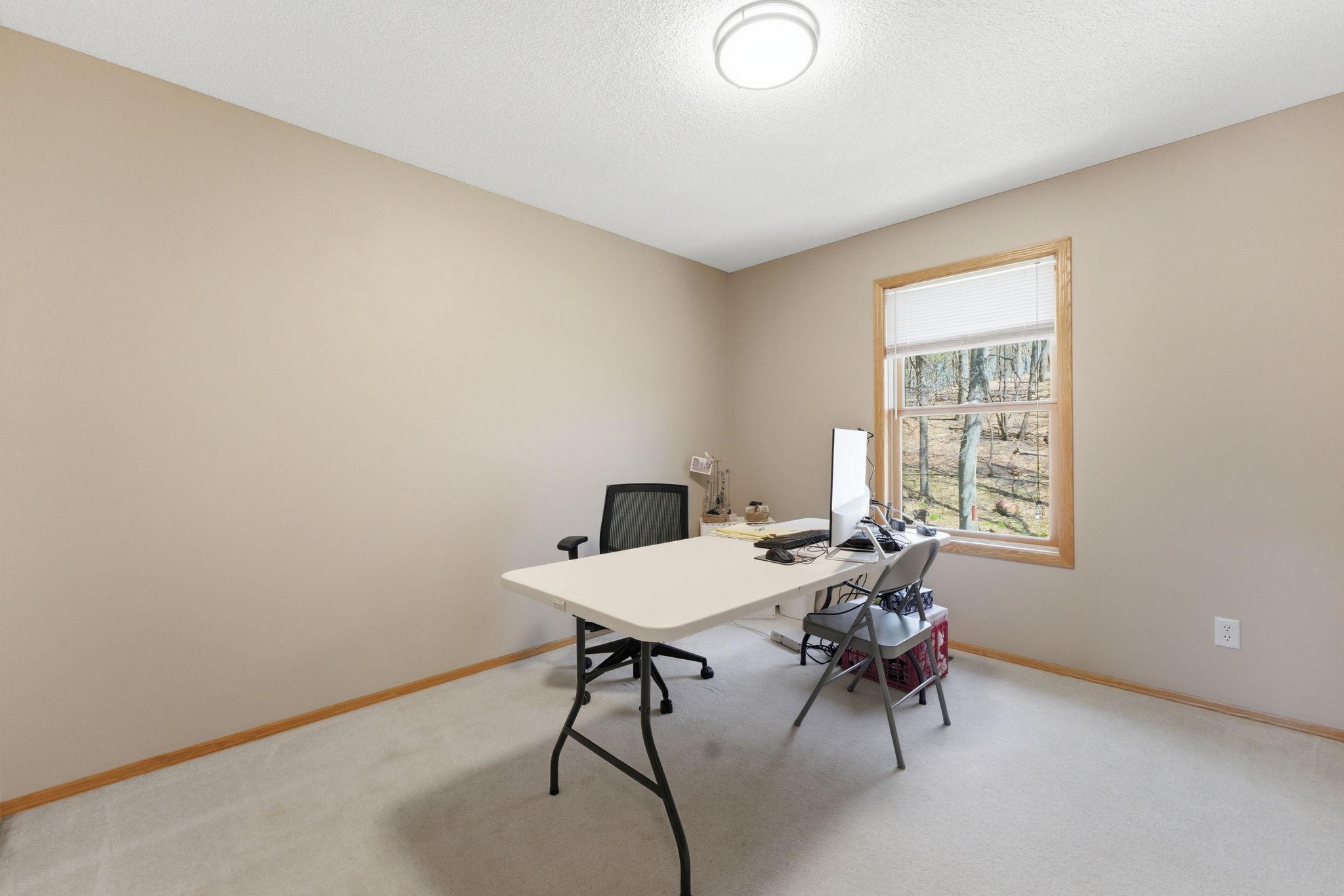 Bedroom 3 with window overlooking backyard