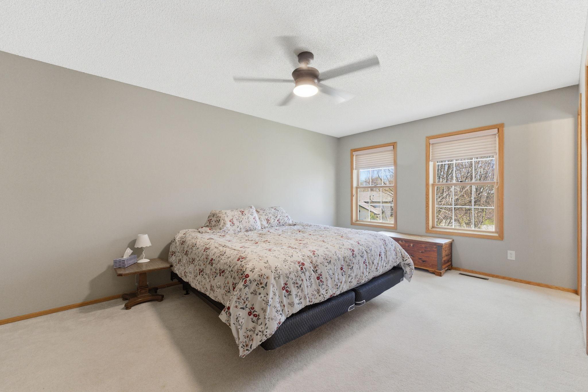 Spacious Primary bedroom with ceiling fan, walk-in closet, and private 3/4 bathroom.
