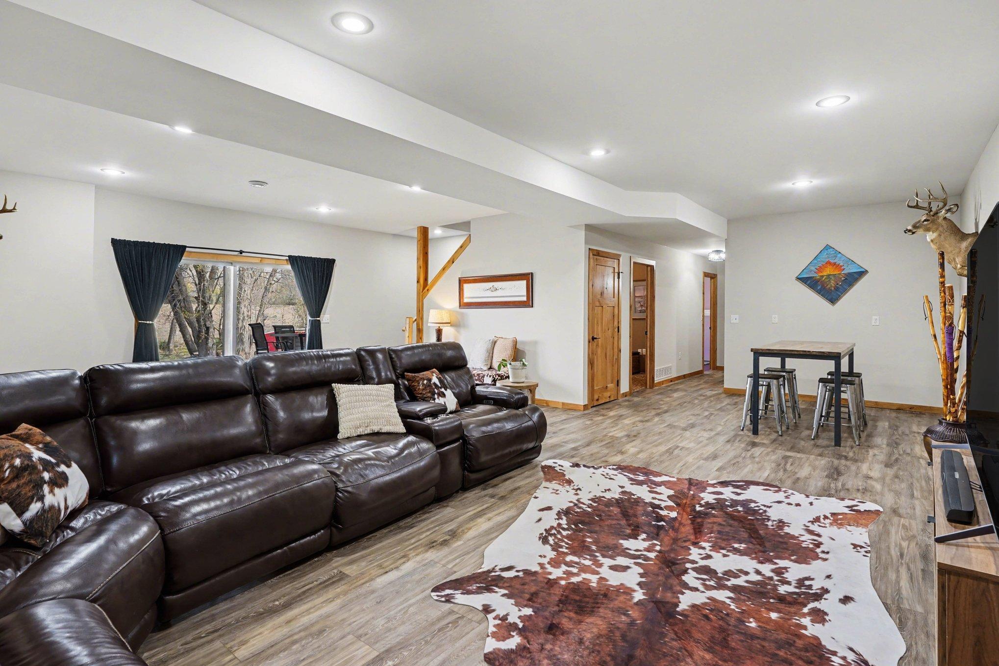 Recently finished lower level finished in knotty alder and luxury vinyl.