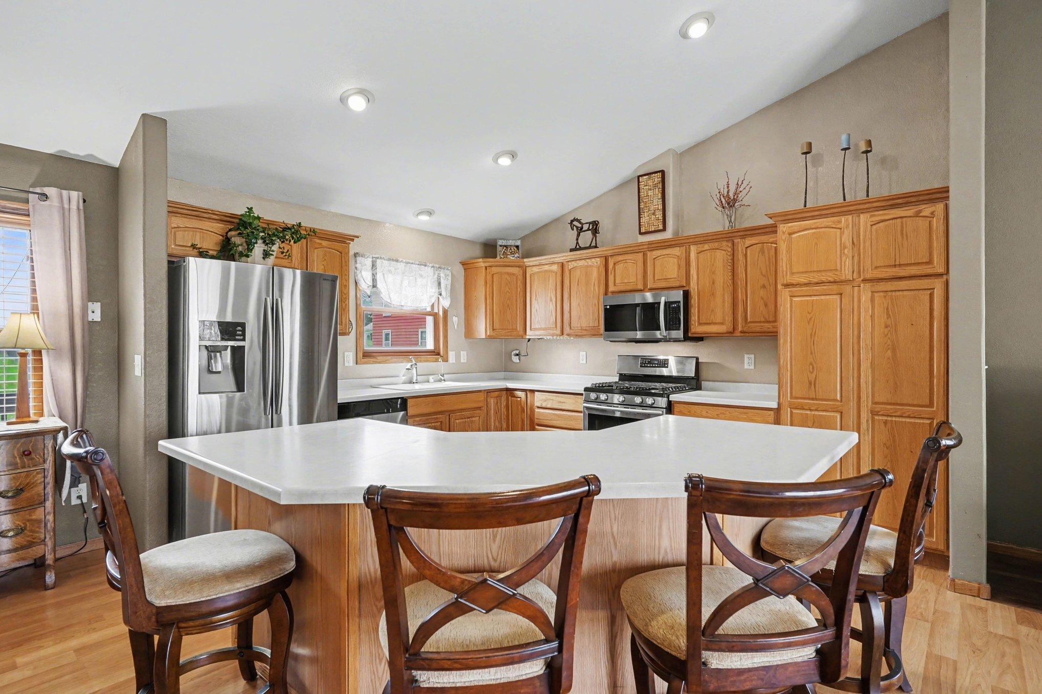 A polished kitchen with stainless steel appliances and gas range!