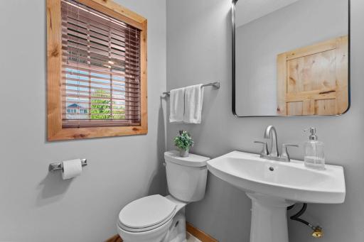 Conveniently located nearby is a half bathroom, while direct access to the attached three-car garage from the laundry room adds everyday practicality and convenience.