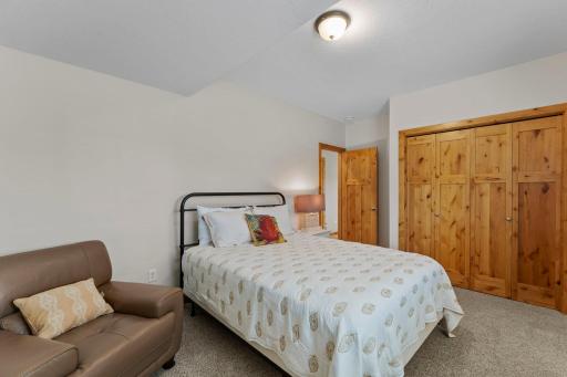 The lower level also includes a fifth bedroom with carpeting, a lookout window, and ample closet space.