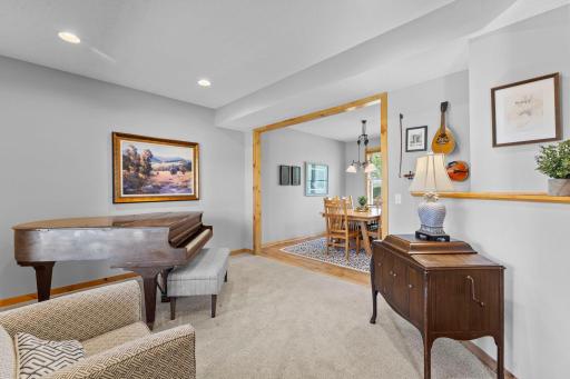 The front-facing sitting room, accessible from both the foyer and dining room, provides a versatile space perfect for a home office, reading nook, or additional gathering area.