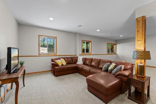 The finished lower level provides an expansive family room with recessed lighting, carpeting, and lookout windows that fill the space with natural light.