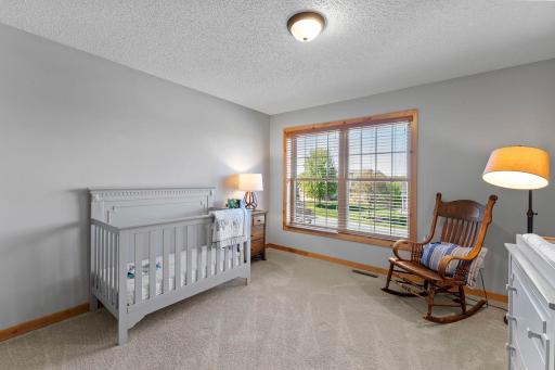 Bedroom four, located adjacent to bedroom three, features a large front-facing window that fills the room with natural light.