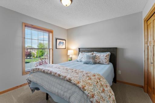 Bedroom three, located across the hall from bedroom two, features comfortable carpeting and ample closet space.