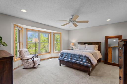 The upper level features four bedrooms, including a spacious primary suite complete with carpeting, a large bay window, ceiling fan, and a generous 10 x 6 walk-in closet.