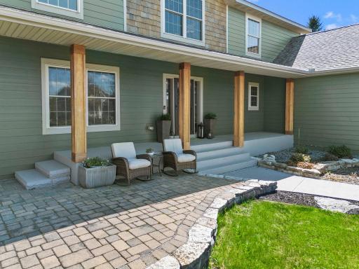 As you arrive, the charming front patio and covered porch create a warm first impression.