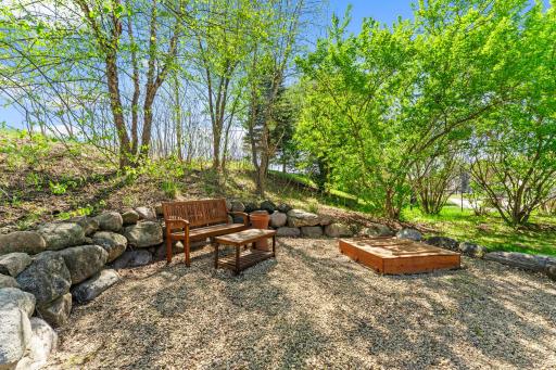 A relaxing backyard sitting area, perfect for reading a book, unwinding after a long day, or simply taking in the beautiful surroundings.