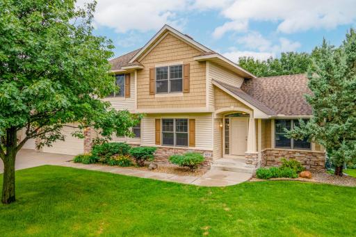 Well-maintained exterior with lush lawn, mature shade trees, and timeless architectural details.