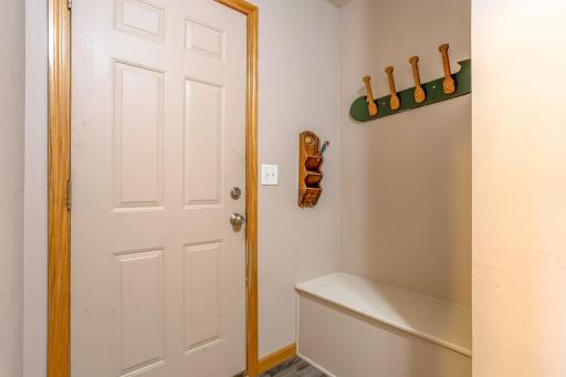 Built-in bench and coat storage create a practical drop zone for keeping everyday essentials organized.