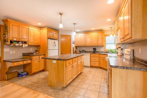 The oversized center island provides additional seating and serves as the heart of this inviting kitchen.