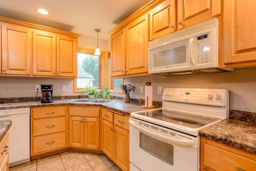 Beautiful wood cabinetry, ample counter space, and a practical layout make meal preparation a breeze.