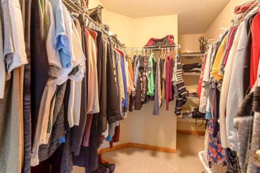 Spacious walk-in closet offers extensive storage and organization for every season.