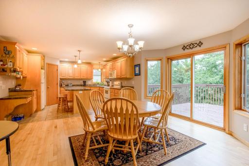 Open dining and kitchen spaces are enhanced by expansive windows, natural light, and beautiful backyard views.