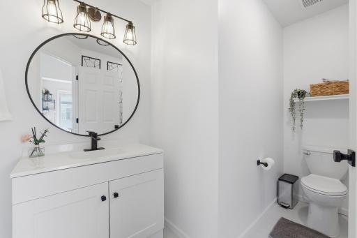 A beautiful half bathroom is conveniently located off the living area.