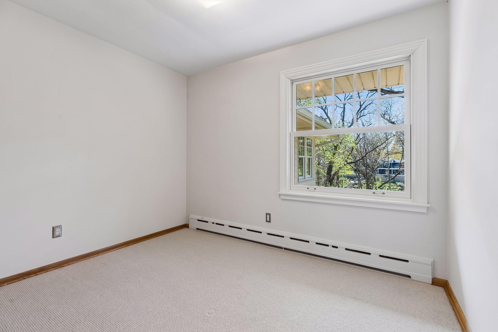 Two more bedrooms on the main floor have lovely views of the back yard and creek valley.
