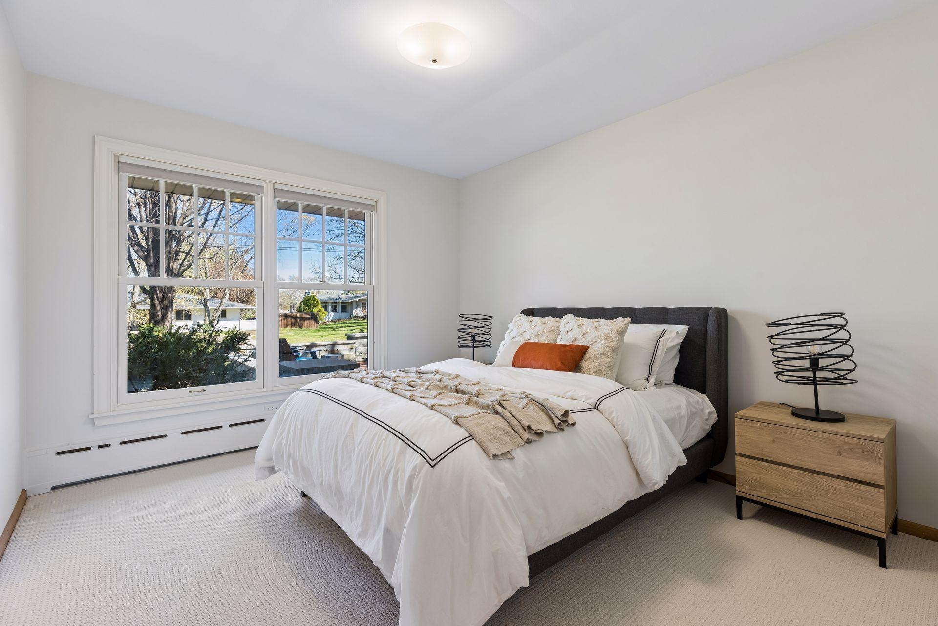 The main floor owners suite has oversized Marvin windows, newer carpet and a fresh neutral decor.